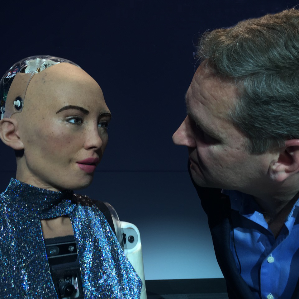 Jaakko looking at Sofia the AI robot